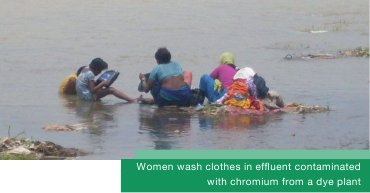 Women washing clothes in effluent contaminated with chromium from a dye plant